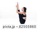 Beautiful sporty woman doing advanced yoga practice on white bac 82503860