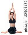 Beautiful sporty woman doing advanced yoga practice on white bac 82504189