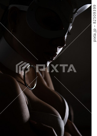 Woman in mask touching breast Woman in mask touching breast 82509399