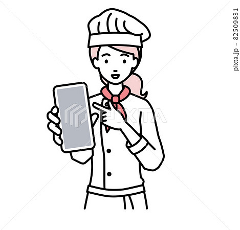 立ってスマートフォンを指差してこちらに向けて見せている調理師の女性 82509831