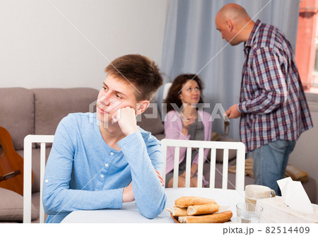 Upset teenager suffering from mom and dad arguing 82514409