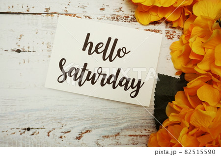 Hello Saturday Card with Blooming flower on wooden background Hello Saturday Card with Blooming flower on wooden background 82515590