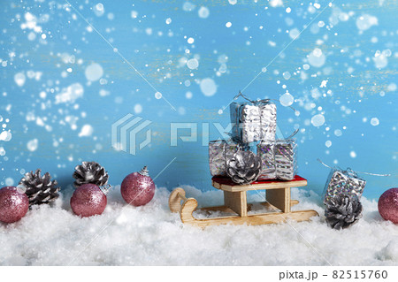 Sleds and New Year's gifts in the snow. Christmas decor. 82515760