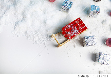 Sleds and New Year's gifts in the snow. Christmas decor. 82515761