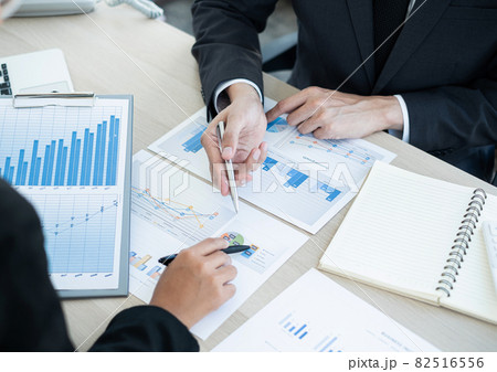 Two business leaders talk about charts, financial graphs showing results are analyzing and calculating planning strategies, business success building processes 82516556