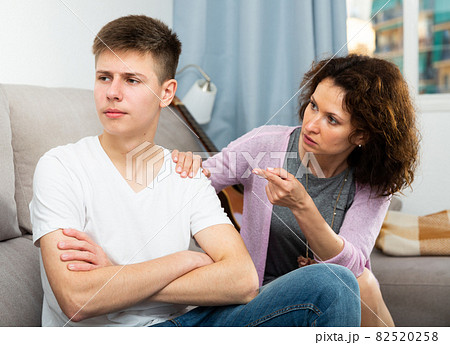 Worried mother talking to son Worried mother talking to son 82520258