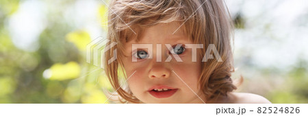 Happy little smiling child on a natural background walking in the park Happy little smiling child on a natural background walking in the park 82524826