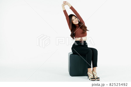 Portrait of young and self-confidence brunette Asian girl with smile and friendly face. Charming girl sitting poses with rejoicing and happy isolated on white background with advertising gesture Portrait of young and self-confidence brunette Asian girl with smile and friendly face. Charming girl sitting poses with rejoicing and happy isolated on white background with advertising gesture 82525492