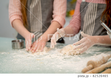 Close up hand of two woman thresh flour for cooking with other tools or accessories in the kitchen 82526465