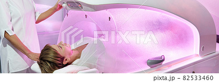 Modern spa treatment capsule in cosmetology clinic, cosmetologist operating equipment Modern spa treatment capsule in cosmetology clinic, cosmetologist operating equipment 82533460