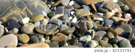 Pattern with turquoise sea stones beach on for design. Beautiful gravel background. Stone texture. Image For desktop, wallpapers, banner. 82533791