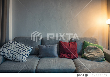 Modern grey fabric sofa with pillows and lighting lamp Modern grey fabric sofa with pillows and lighting lamp 82533879