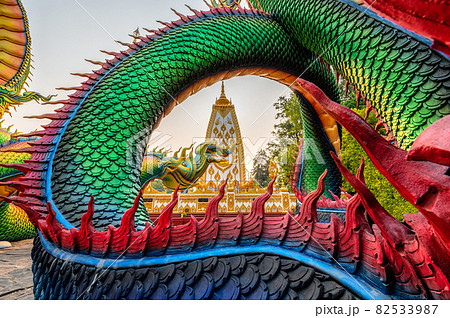 Colorful Thai Naga surrounding Sri Maha Pho Chedi stupa in the sunset at Wat Phra That Nong Bua Colorful Thai Naga surrounding Sri Maha Pho Chedi stupa in the sunset at Wat Phra That Nong Bua 82533987