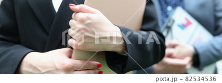 Businesswoman and businessman holding documentation in their hands Businesswoman and businessman holding documentation in their hands 82534536