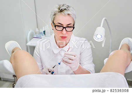 Gynecologist holding an IUD birth control device before using it for patient 82536308