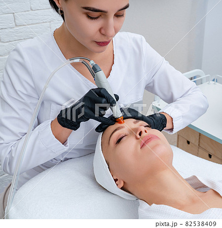 Face Skin Care. Closeup Of Woman Face Cleansing At Cosmetology clinic, vacuum cleaning 82538409