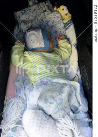 Beautiful sleeping baby boy with child hat posing photographer for color photo 82539122