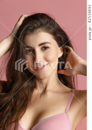 Close-up portrait of young beautiful girl without makeup isolated over pink studio background. Natural beauty concept. Close-up portrait of young beautiful girl without makeup isolated over pink studio background. Natural beauty concept. 82539691