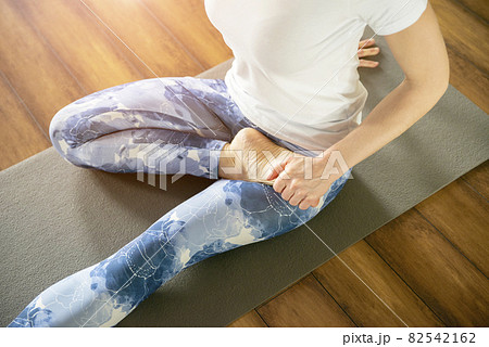 fitness, sport, training and lifestyle concept - woman stretching on mat in gym fitness, sport, training and lifestyle concept - woman stretching on mat in gym 82542162
