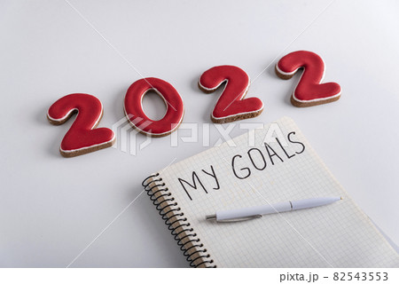 Notebook with inscription My goals, pen and numbers 2022 on white background. Close up 82543553