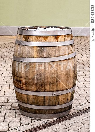 brown oak barrel with iron hoops stands in the town square 82543852