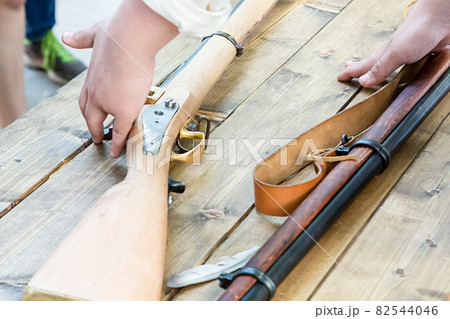 weapon flintlock light beige butt lies on a wooden table 82544046