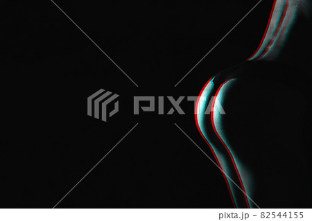beautiful silhouette of a woman's buttocks on a dark background with a copy space. Black and white with 3D glitch virtual reality effect 82544155