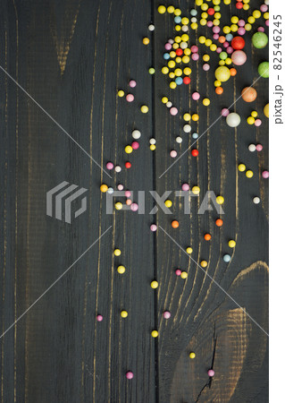 Colorful Foam ball on a black wooden background Colorful Foam ball on a black wooden background 82546245