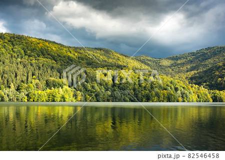 Picturesque landscape with clear lake and autumn forest on his coast 82546458