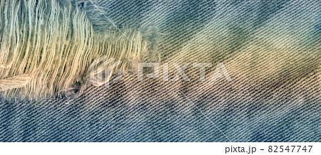 Blue denim jean texture background. Jeans torn fabric texture 82547747