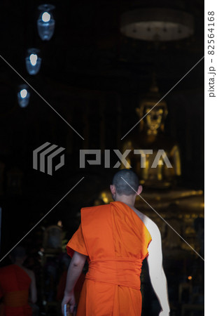 Buddhist monks walking into the main vihan for praying and pay respect Buddha image. Buddhist monks walking into the main vihan for praying and pay respect Buddha image. 82564168