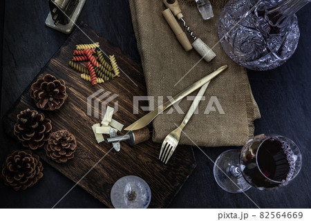 Flat lay composition with pitcher and glasses of red wine and corkscrew on wooden background : traditional winemaking and wine tasting concept. 82564669