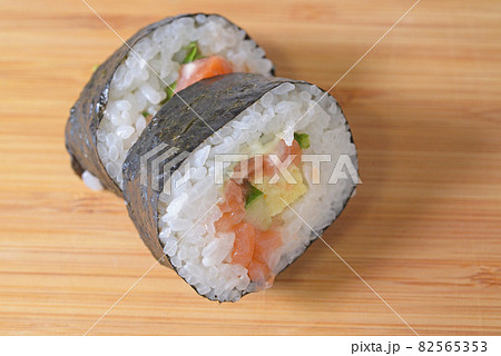 Top view of roll sushi on cutting board. Japanese healthy food Top view of roll sushi on cutting board. Japanese healthy food 82565353
