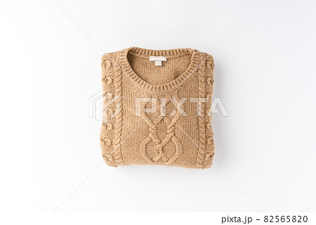 Beige folded sweater isolated on white background. Flat lay. Top view Beige folded sweater isolated on white background. Flat lay. Top view 82565820