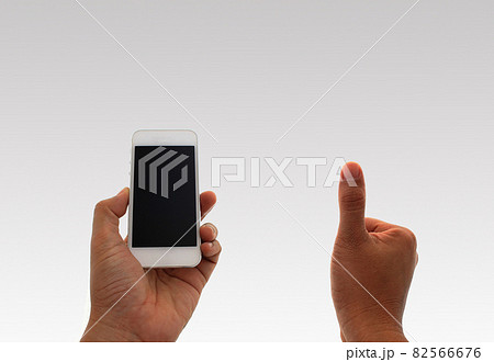 a man using hand holding the smartphone and thumb up a man using hand holding the smartphone and thumb up 82566676
