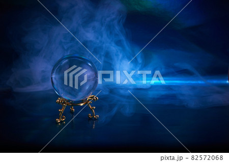 Crystal ball in a dark blue smoky background. Guessing for the future. 82572068