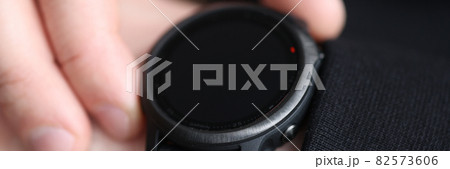 Smart watch with black bracelet on man hand 82573606