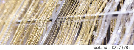 Gold jewelry chains and bracelets on showcase in store 82573705
