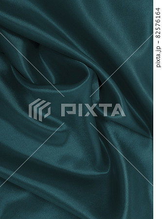 Smooth elegant blue silk or satin luxury cloth texture as abstract background. Luxurious Christmas background or New Year background design 82576164