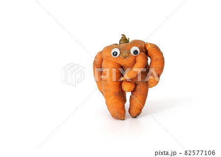 Funny carrot with eyes isolated on white background. Ugly vegetables. Food waste concept. Copy space. 82577106