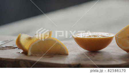 sliced sweet lemon on olive board 82586170