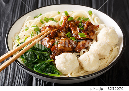 Mie Ayam Pangsit is a delicious Indonesian homemade recipe for noodles, chicken, meatballs bakso closeup in the bowl. Horizontal 82590704