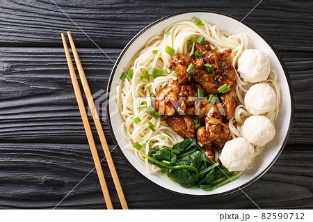 Mie Ayam Pangsit is a delicious Indonesian homemade recipe for noodles, chicken, meatballs bakso closeup in the bowl. Horizontal top view 82590712
