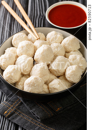 Homemade Indonesian chicken meatballs bakso ayam with sauce close up in the bowl. Vertical 82590713