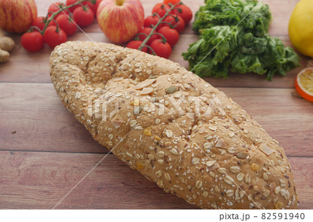 whole meal bread, apple and cherry tomato on table  82591940