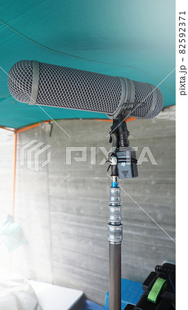Microphone boom type. Sound recorder boom mic and tripod stand. Professional digital audio recording gear mic for making film or video movie production. Wind protection on boom mic. Movie industry 82592371