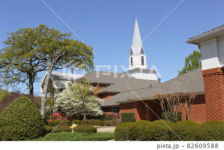 Spring Flowers near walkway to church building and Blue Sky 82609588