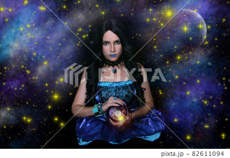 Psychic with Crystal Ball and galaxy background Psychic with Crystal Ball and galaxy background 82611094