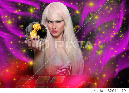 Psychic with blond hair Crystal Ball and tarot cards with galaxy background Psychic with blond hair Crystal Ball and tarot cards with galaxy background 82611140