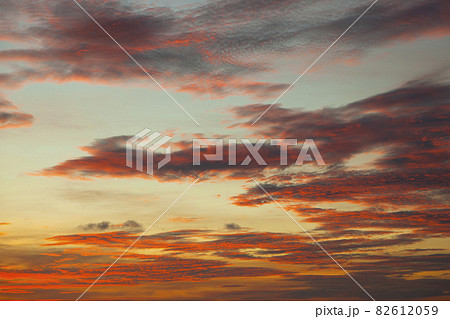 Pink sunset sky background. Picturesque colorful red clouds in the sky. Vast sky landscape, sunset sky view. Pink sunset sky background. Picturesque colorful red clouds in the sky. Vast sky landscape, sunset sky view. 82612059